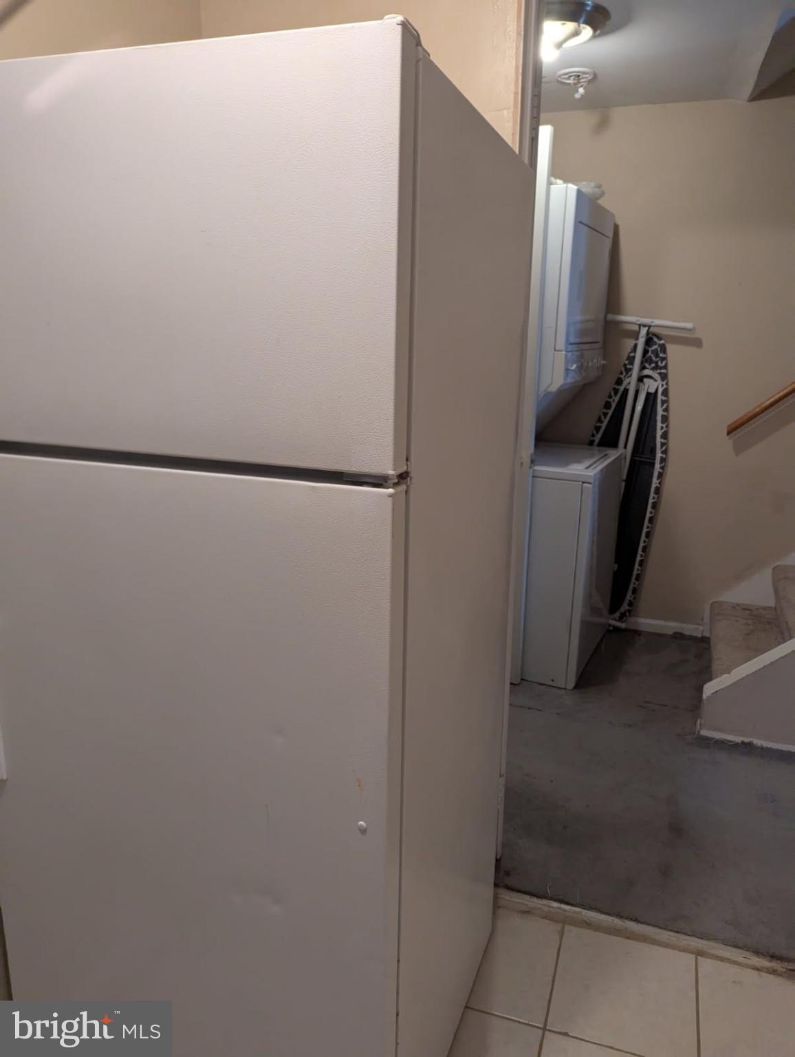 6945 Rockfield Road Baltimore, MD 21244 - Photo 5 of 10 a view of a refrigerator in kitchen and an empty room