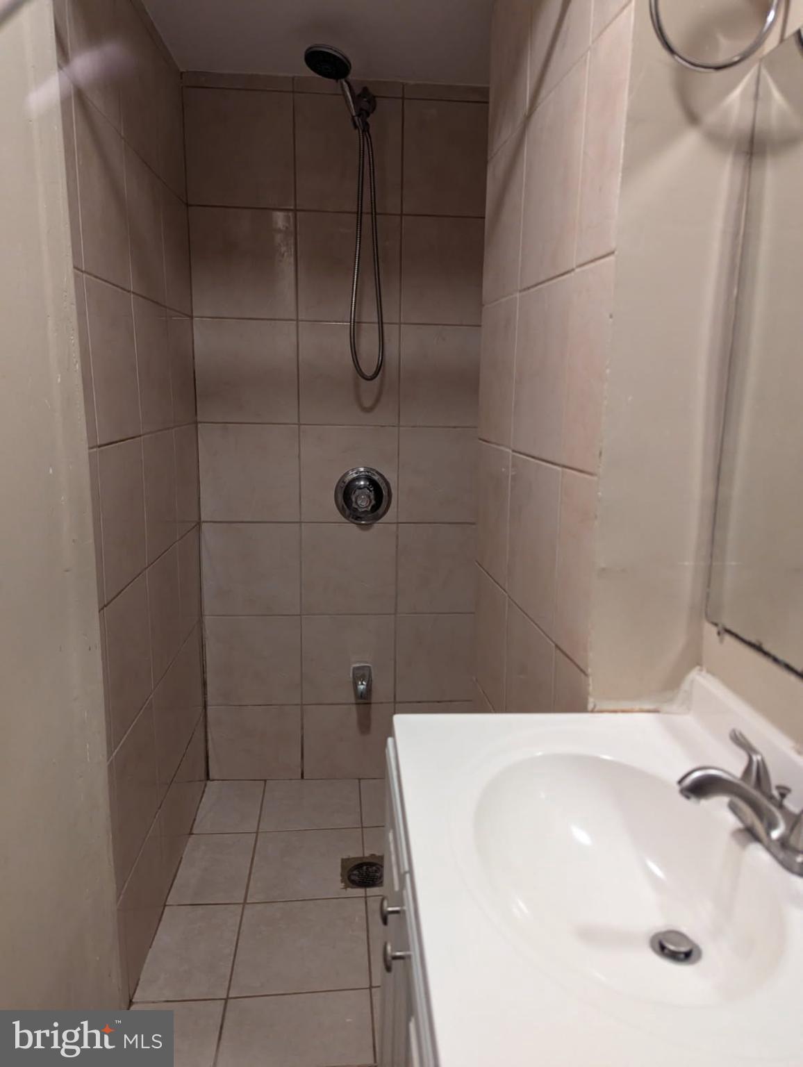 6945 Rockfield Road Baltimore, MD 21244 - Photo 7 of 10 a bathroom with a sink a toilet and shower