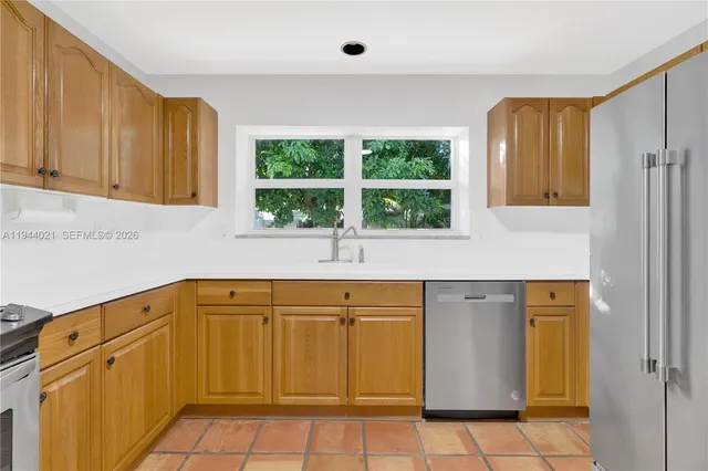 a view of a kitchen with windows and cabinet