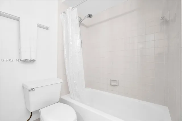 a bathroom with a toilet and a bathtub