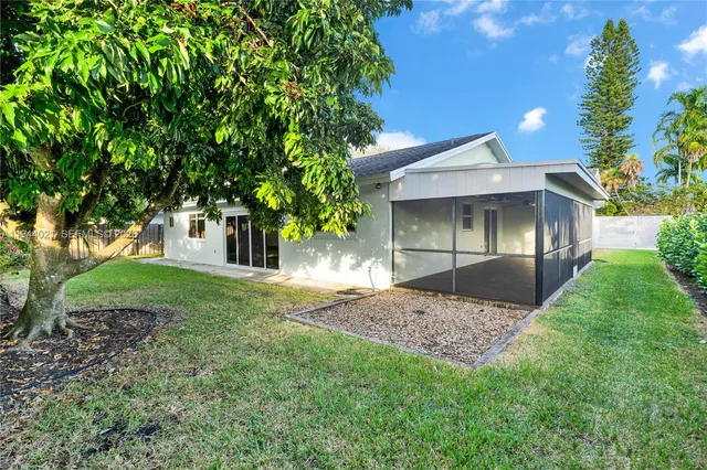 a view of a house with a yard and garden