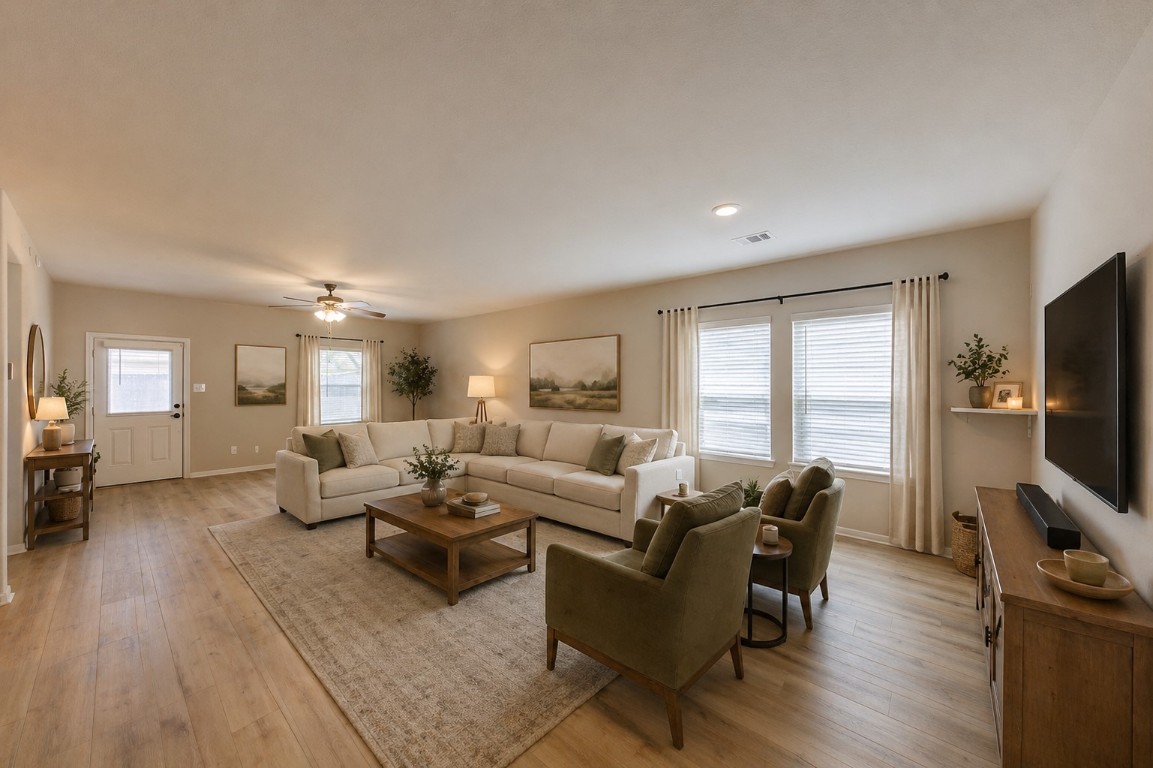 a living room with furniture flat screen tv and wooden floor