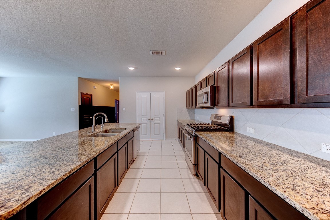 2164 Dale Street Alvin, TX 77511 - Photo 12 of 35 a kitchen with granite countertop stainless steel appliances and sink