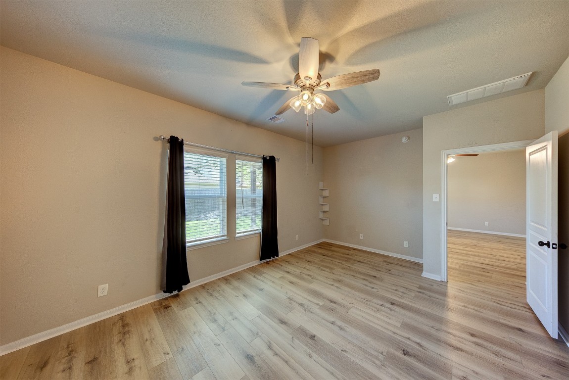 2164 Dale Street Alvin, TX 77511 - Photo 16 of 35 a view of an empty room with a window and wooden floor