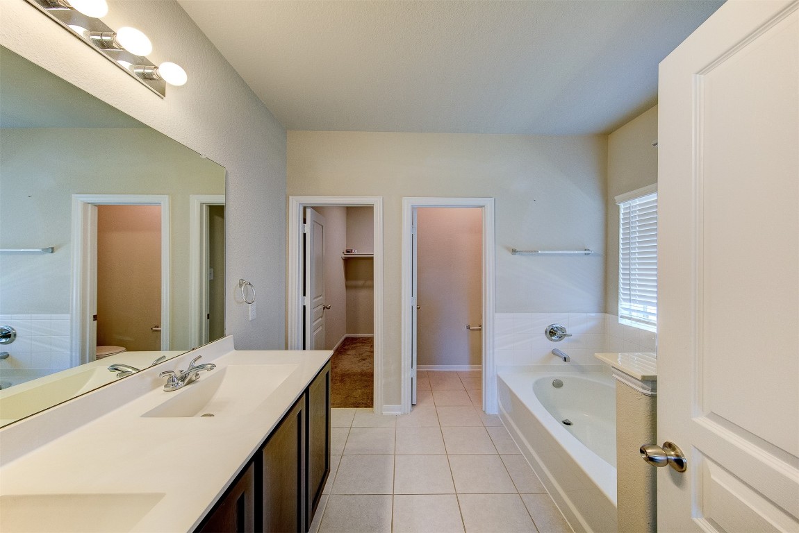 2164 Dale Street Alvin, TX 77511 - Photo 18 of 35 a bathroom with a tub sink and mirror