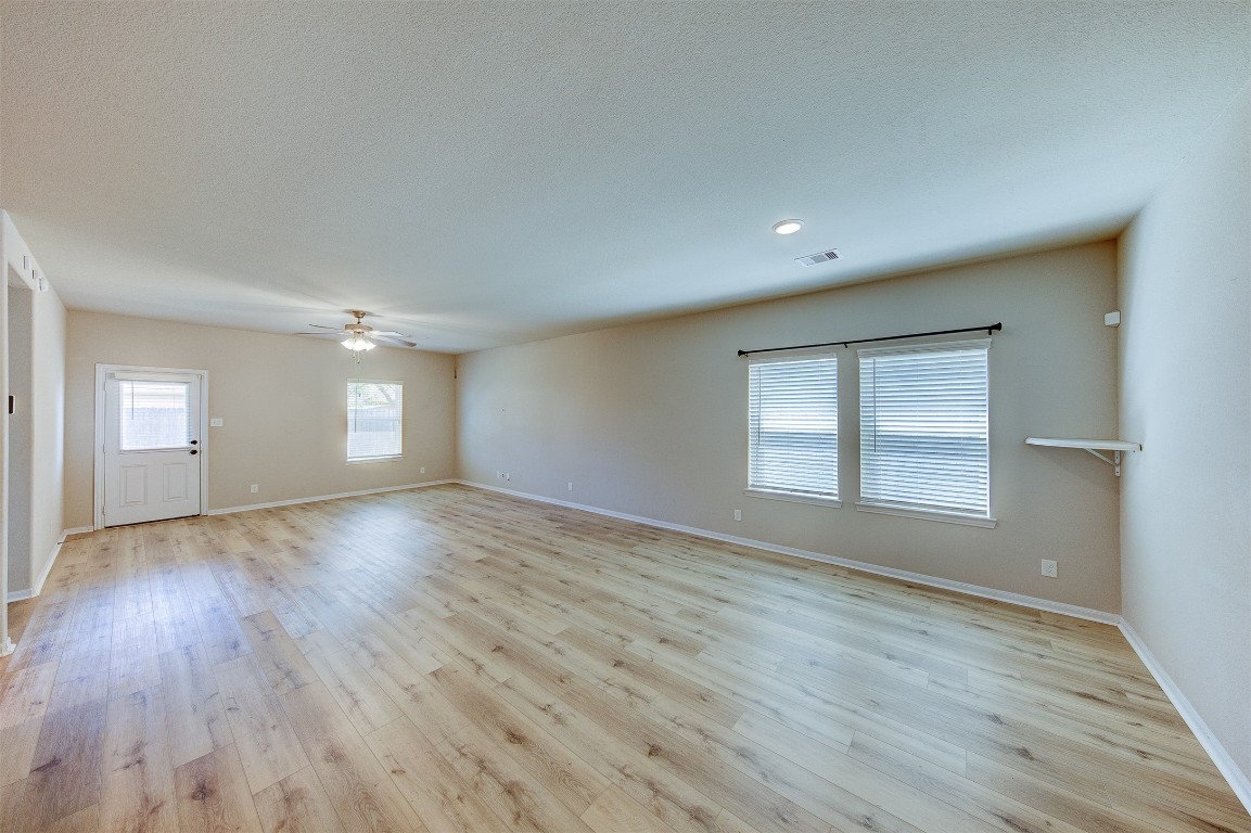 2164 Dale Street Alvin, TX 77511 - Photo 2 of 35 an empty room with wooden floor and windows