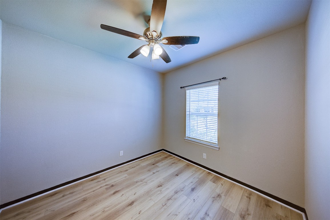 2164 Dale Street Alvin, TX 77511 - Photo 24 of 35 an empty room with a window and a fan