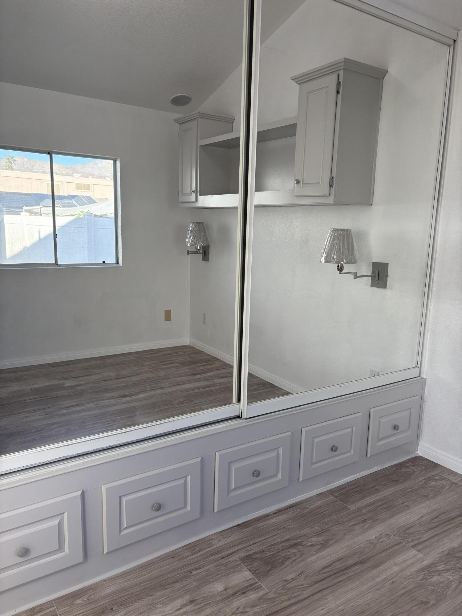74711 Dillon Road, Unit 819 Desert Hot Springs, CA 92241 - Photo 12 of 41 a view of a storage and utility room with wooden floor