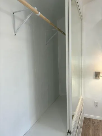 a white toilet sitting next to a bath tub