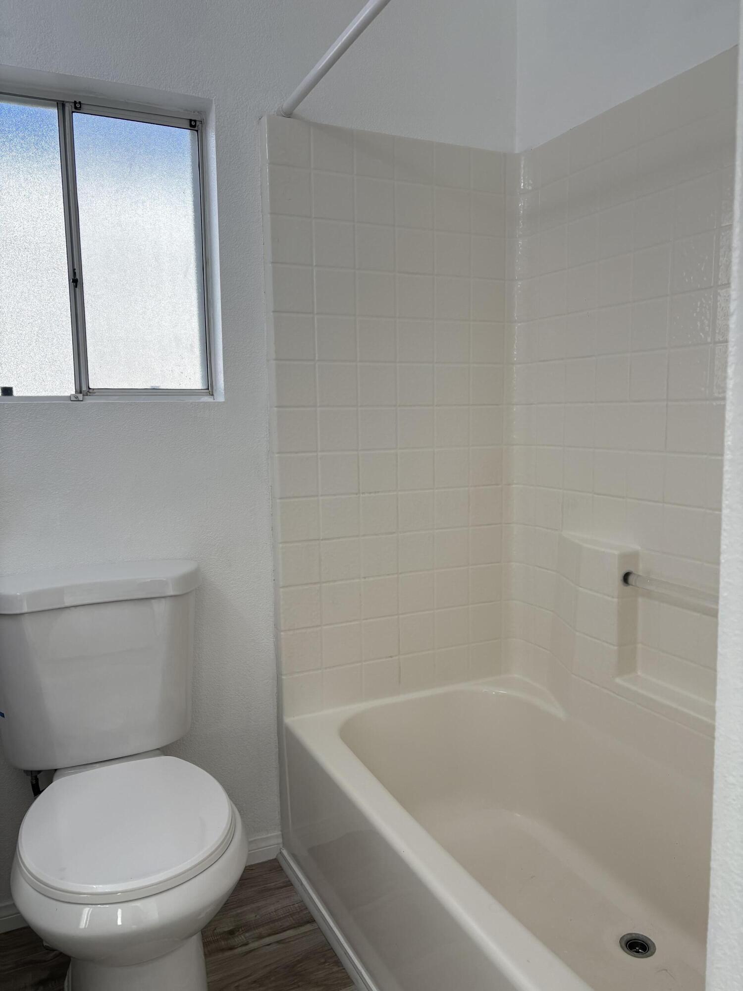 74711 Dillon Road, Unit 819 Desert Hot Springs, CA 92241 - Photo 15 of 41 a white toilet sitting next to a bath tub