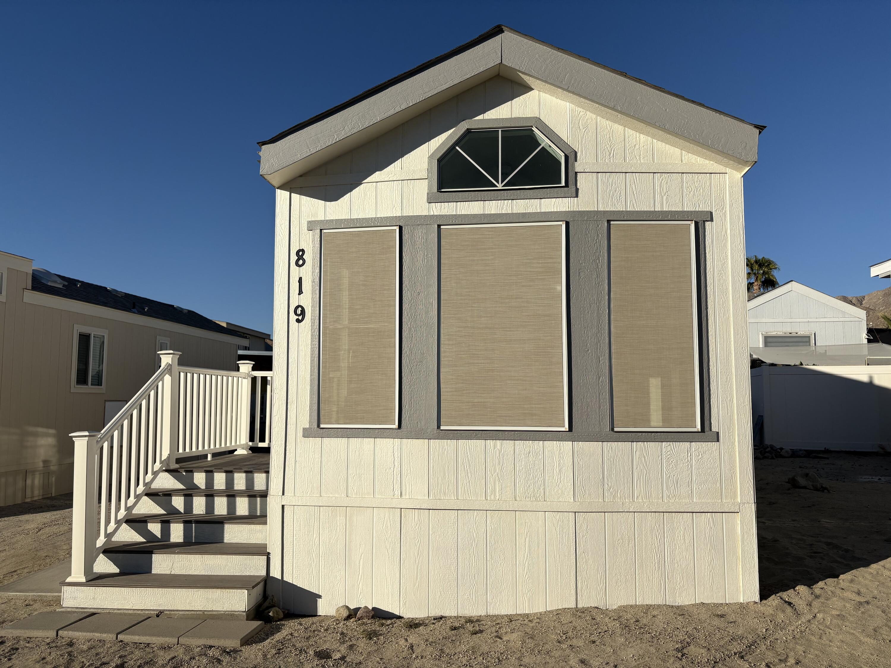 74711 Dillon Road, Unit 819 Desert Hot Springs, CA 92241 - Photo 16 of 41 a front view of a house with a yard