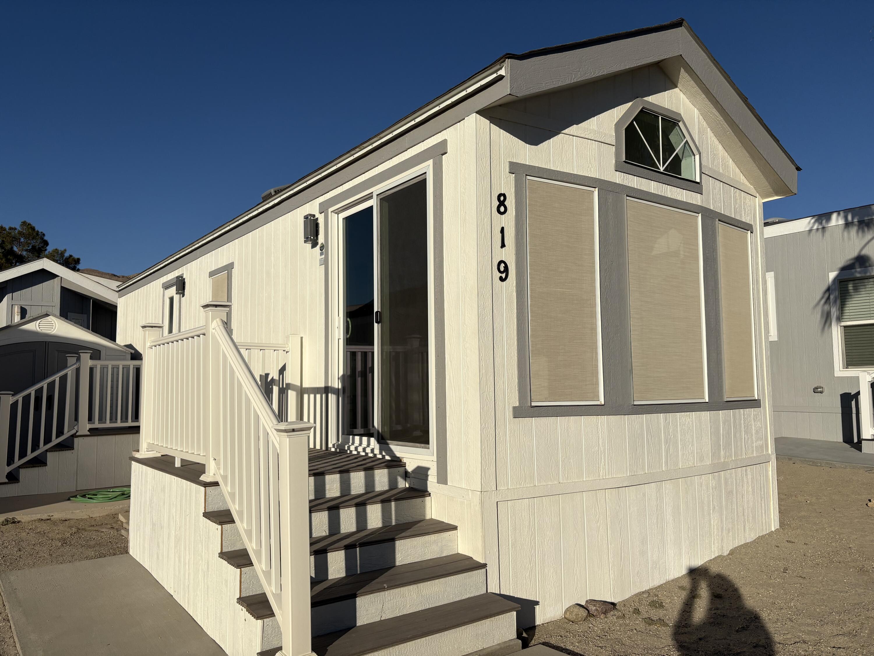 74711 Dillon Road, Unit 819 Desert Hot Springs, CA 92241 - Photo 17 of 41 a front view of a house with wooden stairs