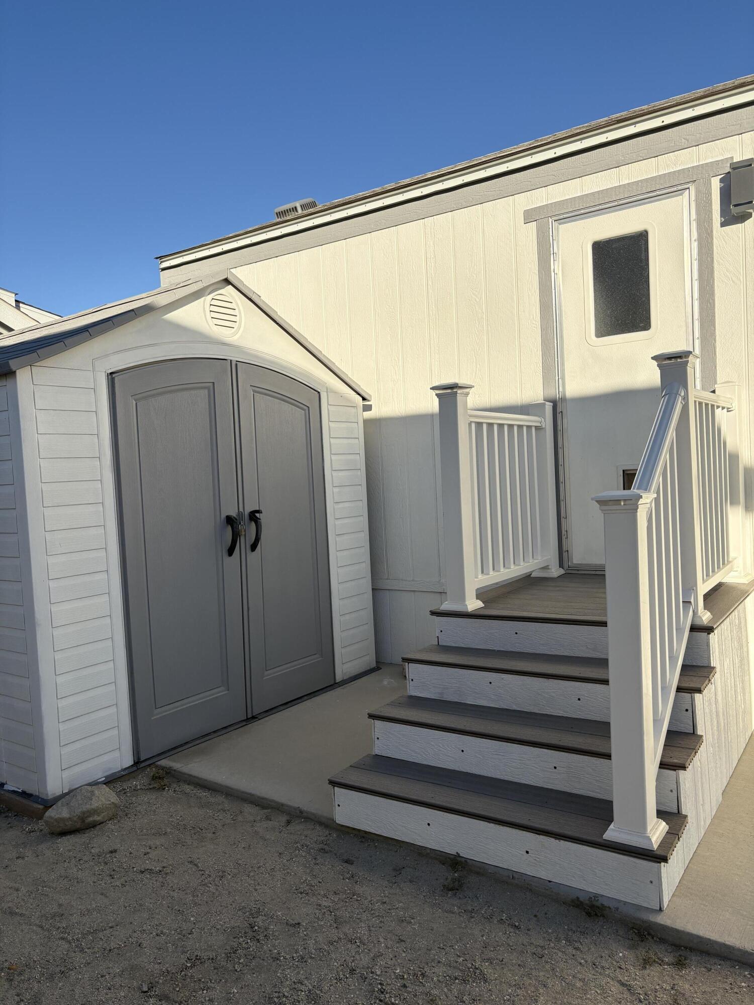 74711 Dillon Road, Unit 819 Desert Hot Springs, CA 92241 - Photo 18 of 41 a view of a porch with wooden floor and stairs