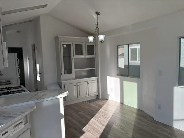 a view of a kitchen with a stove cabinets and wooden floor