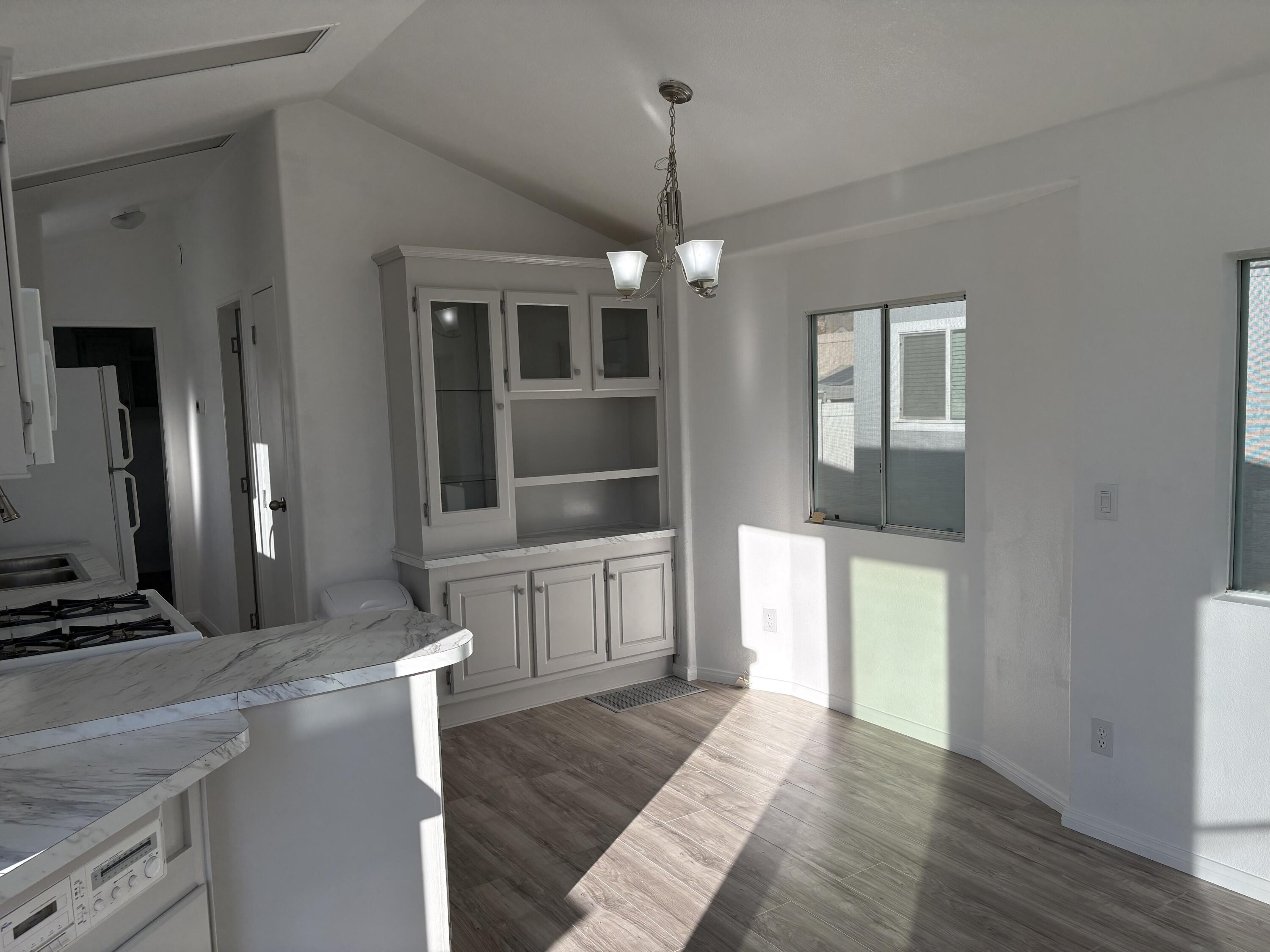 74711 Dillon Road, Unit 819 Desert Hot Springs, CA 92241 - Photo 5 of 41 a view of a kitchen with a stove cabinets and wooden floor