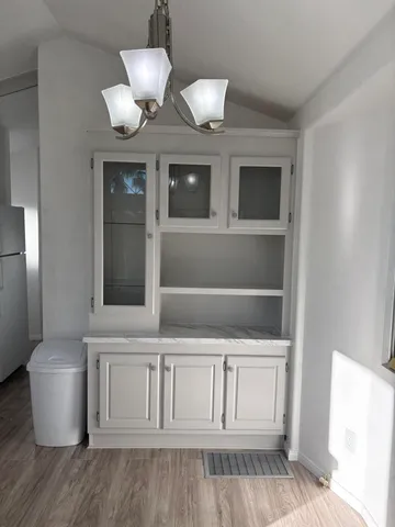 a view of an empty room and wooden floor
