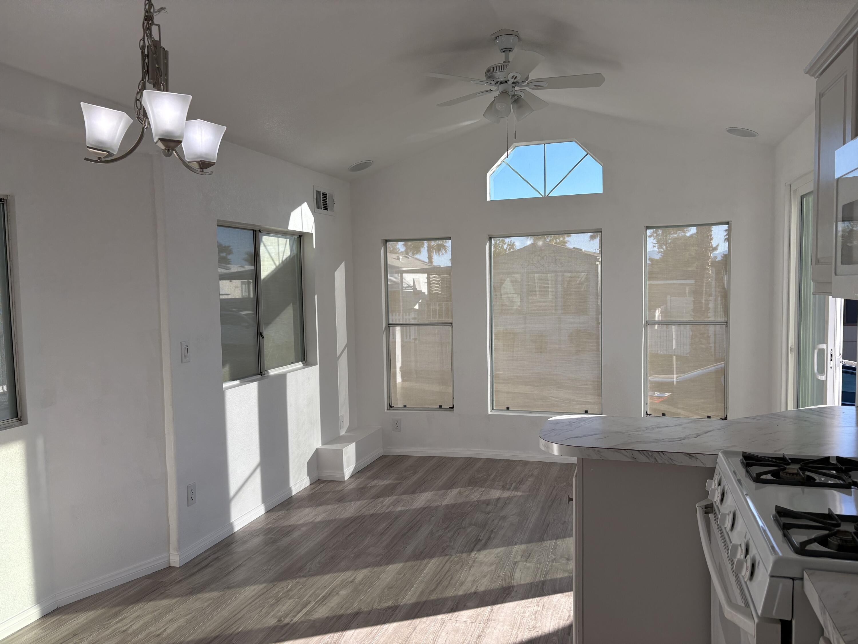 74711 Dillon Road, Unit 819 Desert Hot Springs, CA 92241 - Photo 9 of 41 a view of a kitchen with a table and chandelier