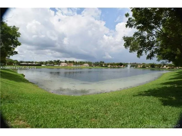 a view of a lake with houses in the back