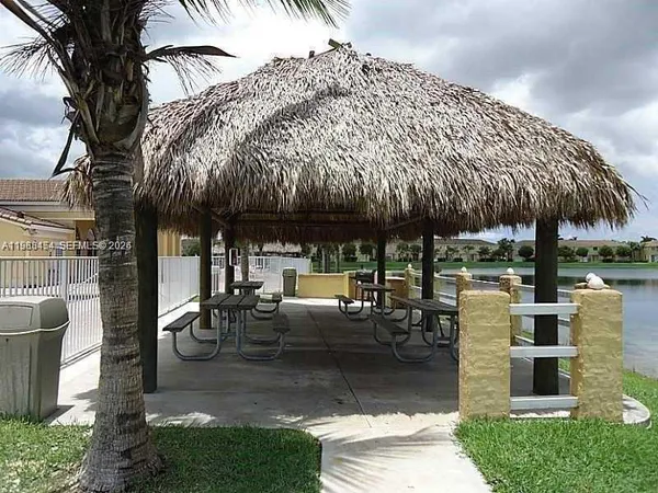 a patio with a table and chairs under an umbrella