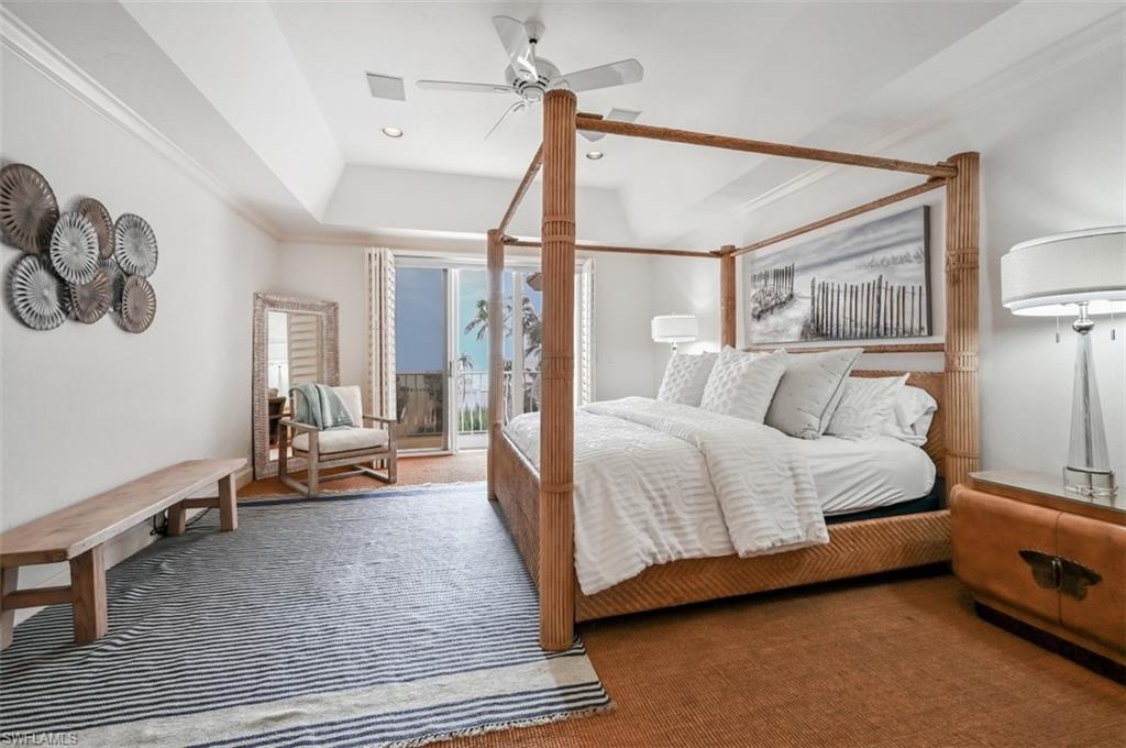 30 Casa Mar Lane Naples, FL 34103 - Photo 15 of 48 a bedroom with a bed and wooden floor
