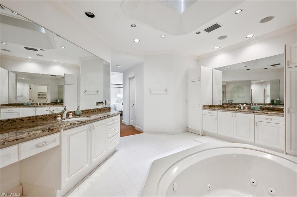30 Casa Mar Lane Naples, FL 34103 - Photo 18 of 48 a large white kitchen with a sink and cabinets