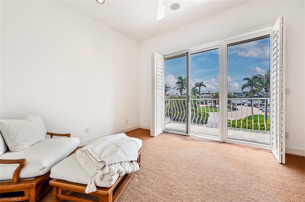30 Casa Mar Lane Naples, FL 34103 - Photo 19 of 48 a view of a bedroom with a bed and glass door