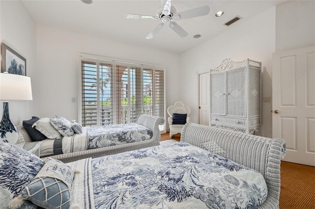 30 Casa Mar Lane Naples, FL 34103 - Photo 23 of 48 a bedroom with a bed and a large window