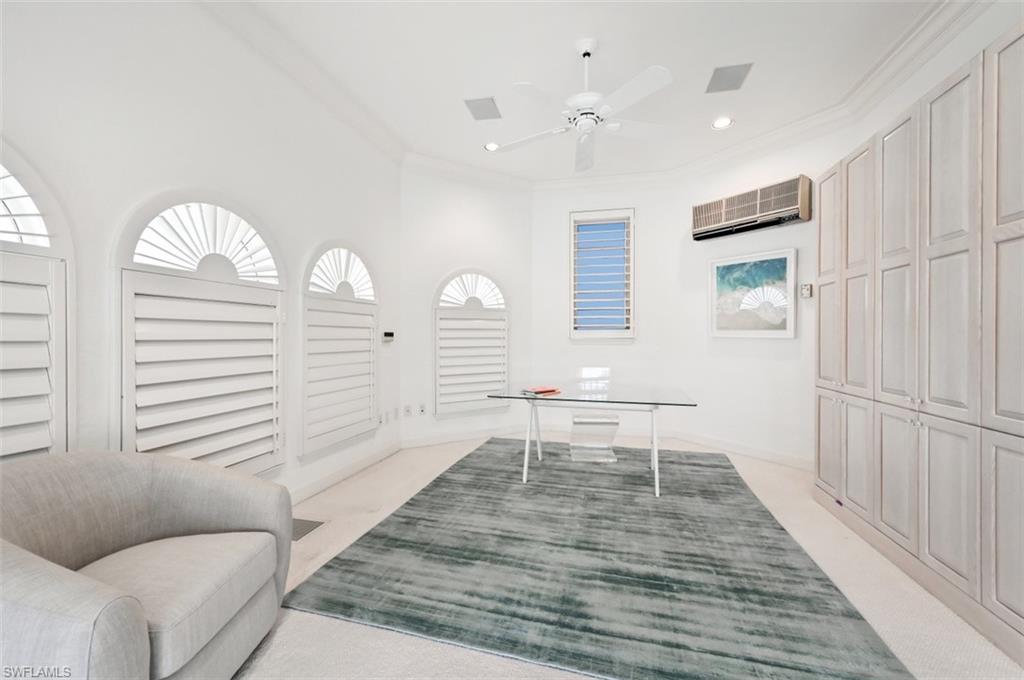 30 Casa Mar Lane Naples, FL 34103 - Photo 24 of 48 a very nice looking room with wooden floor and furniture