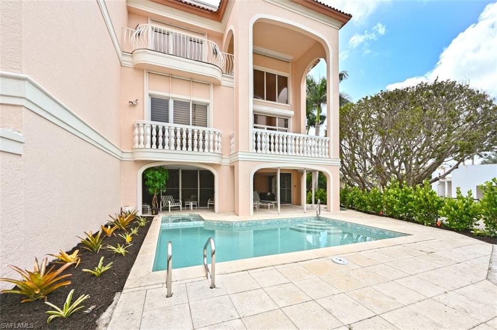 30 Casa Mar Lane Naples, FL 34103 - Photo 3 of 48 a front view of a house with a yard