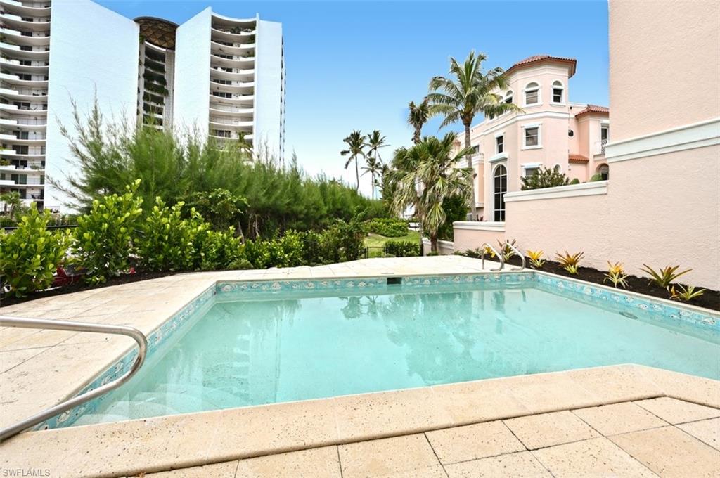 30 Casa Mar Lane Naples, FL 34103 - Photo 35 of 48 a view of a swimming pool with a yard