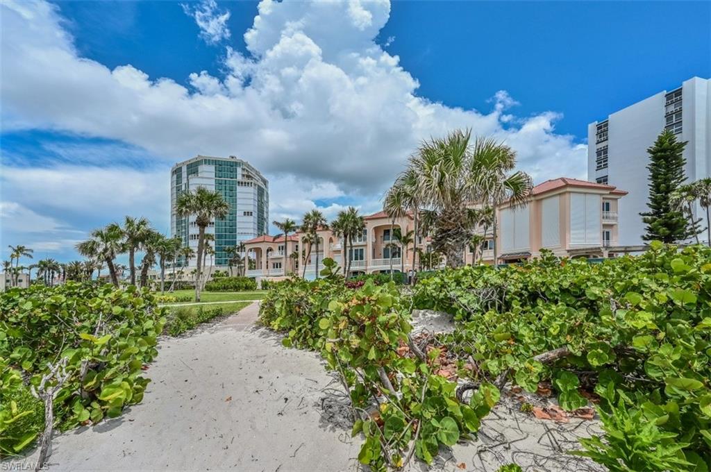 30 Casa Mar Lane Naples, FL 34103 - Photo 4 of 48 a view of a multi story building with a yard