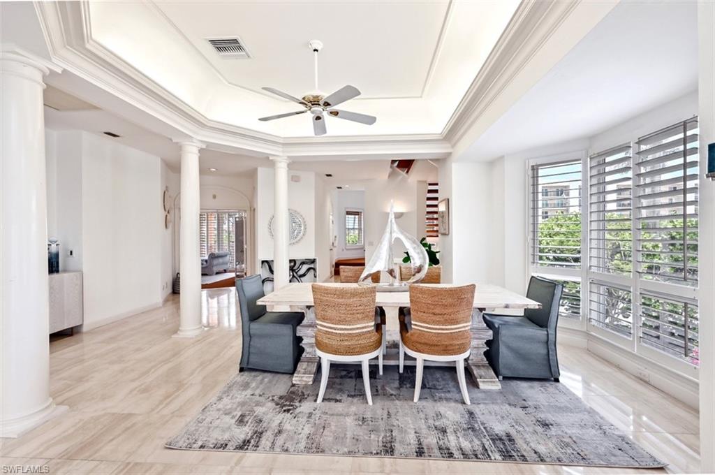 30 Casa Mar Lane Naples, FL 34103 - Photo 7 of 48 a dining room with furniture a chandelier and wooden floor