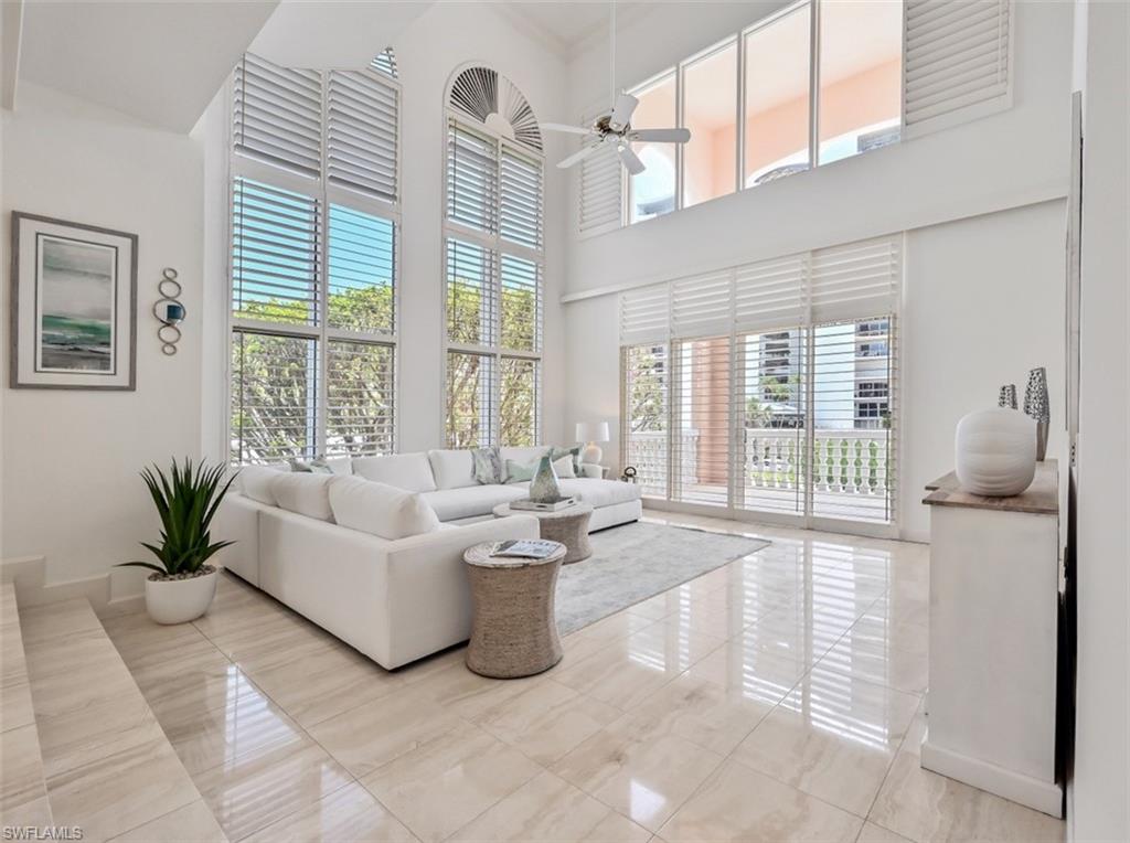 30 Casa Mar Lane Naples, FL 34103 - Photo 8 of 48 a living room with furniture and large windows
