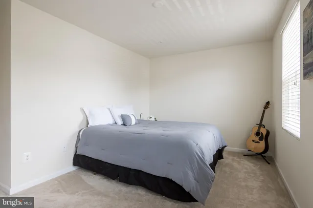 a bedroom with a bed and pillows