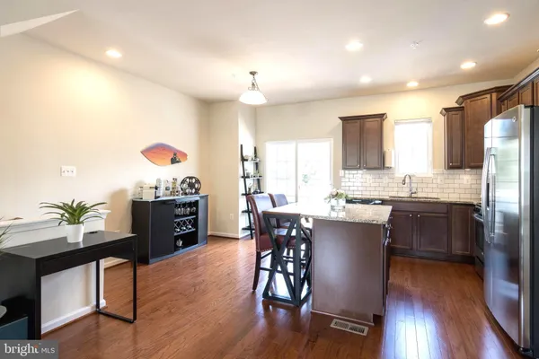a kitchen with a table and chairs in it