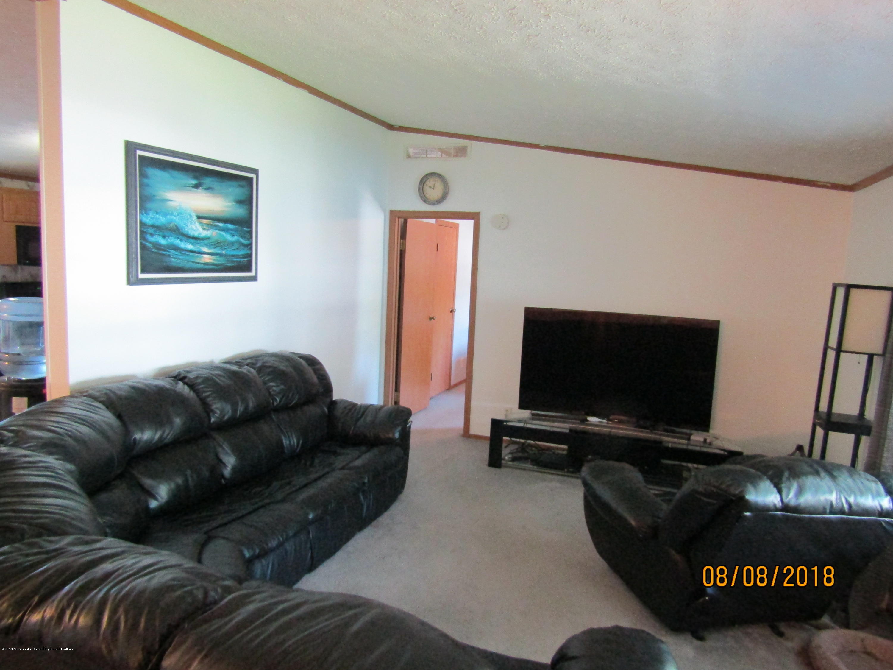 14 Kay Lane Howell, NJ 07731 - Photo 11 of 28 a living room with furniture and a flat screen tv