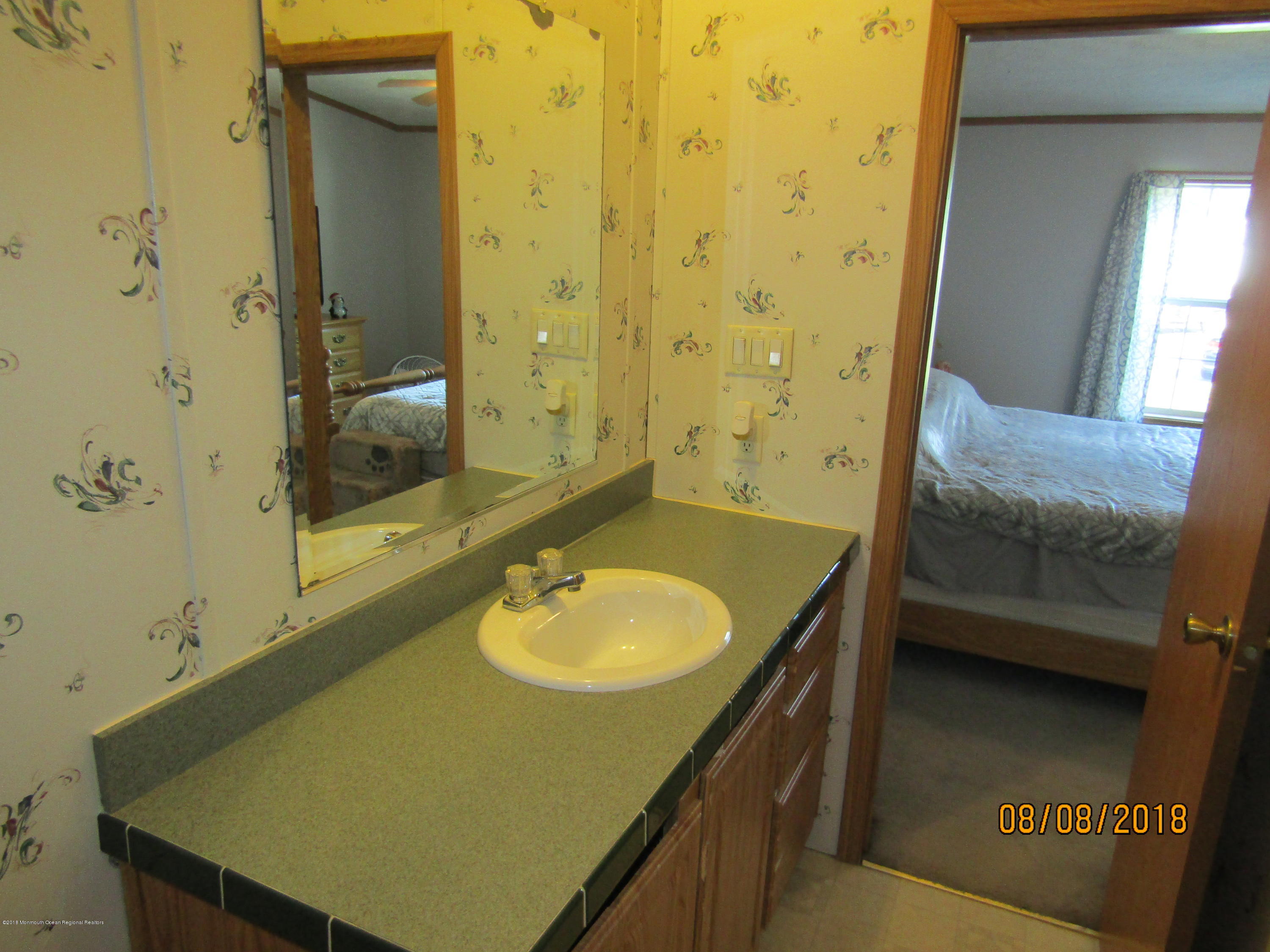 14 Kay Lane Howell, NJ 07731 - Photo 14 of 28 a bathroom with a sink and a mirror