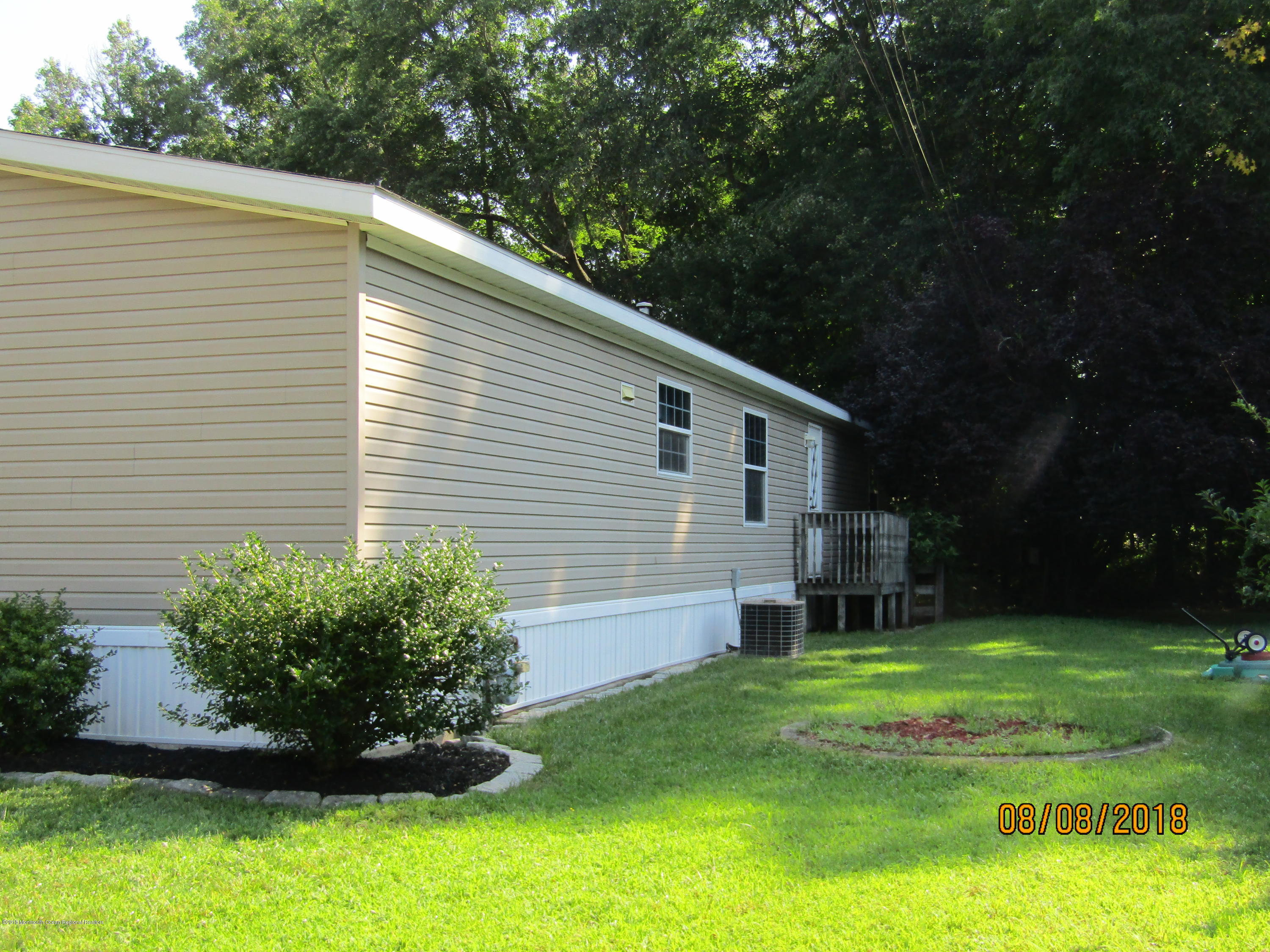 14 Kay Lane Howell, NJ 07731 - Photo 3 of 28 a view of a backyard with plants and large tree