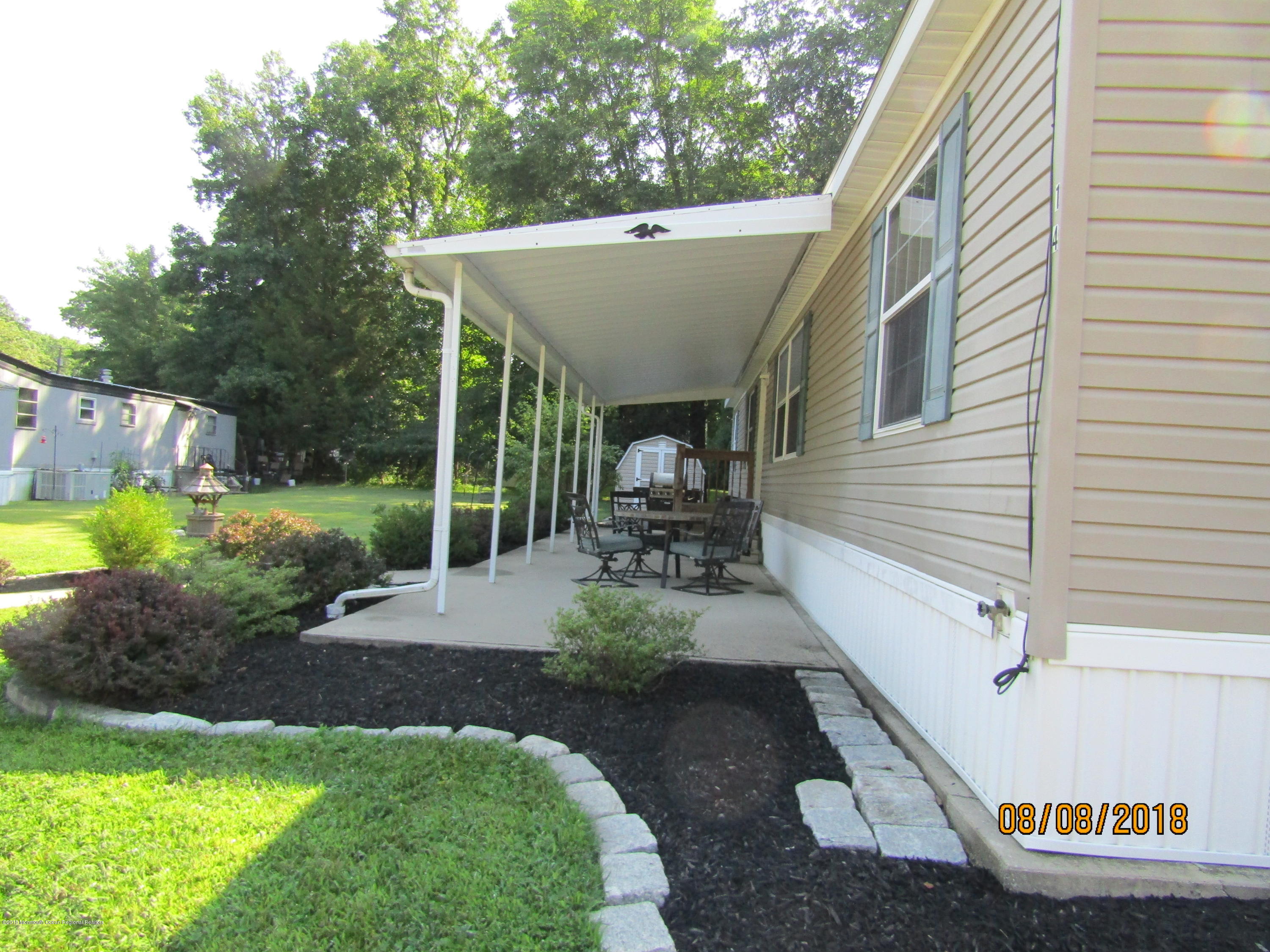 14 Kay Lane Howell, NJ 07731 - Photo 4 of 28 a view of a patio with table and chairs potted plants and large tree
