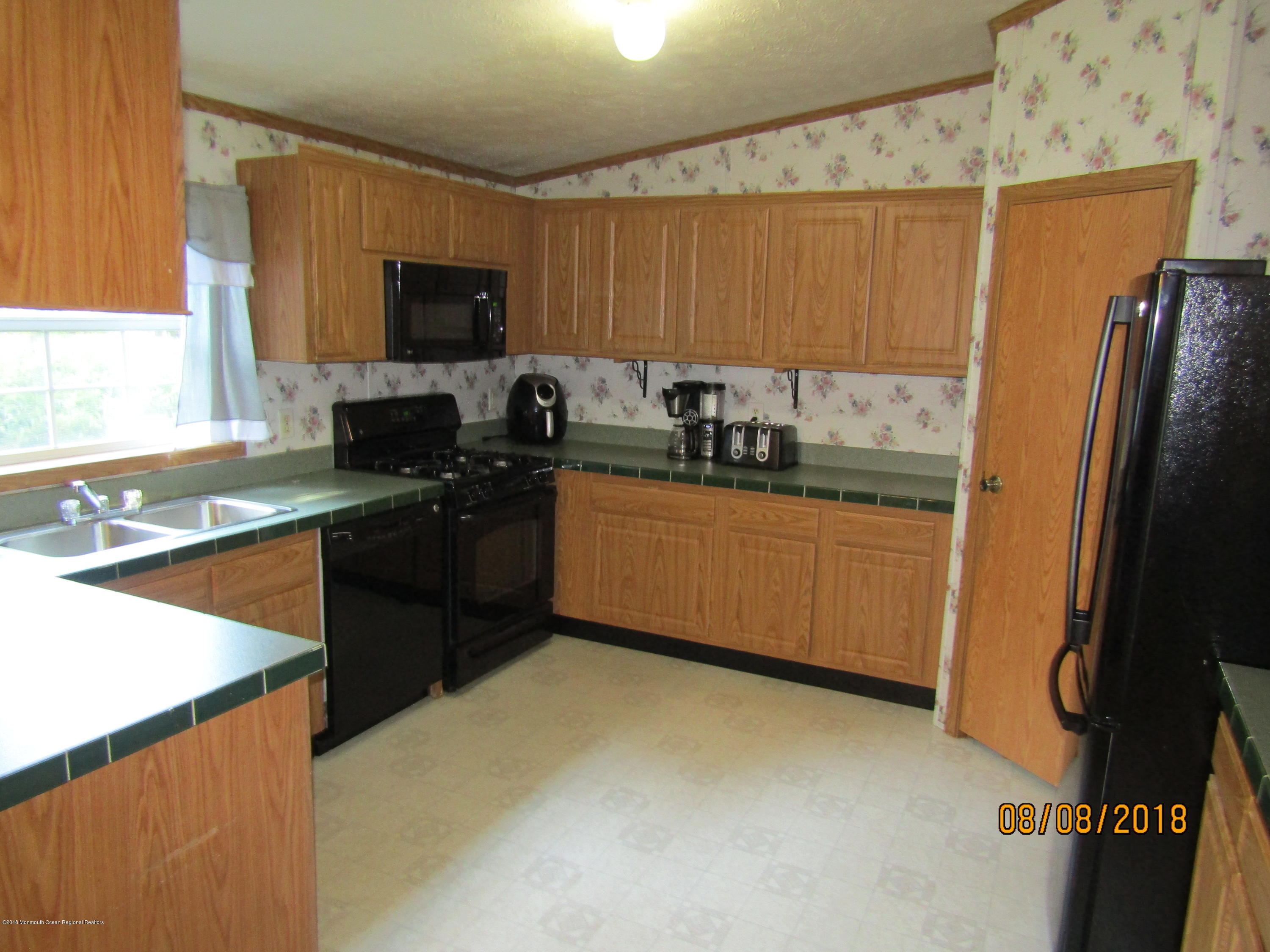 14 Kay Lane Howell, NJ 07731 - Photo 6 of 28 a kitchen with stainless steel appliances a stove refrigerator sink and microwave