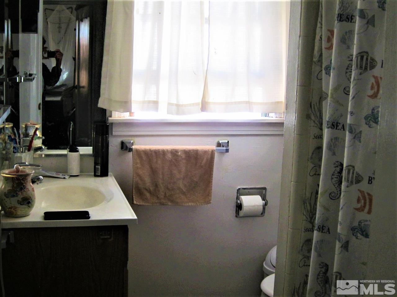 1931 Valley Road Reno, NV 89512 - Photo 17 of 20 a bathroom with a sink and a mirror