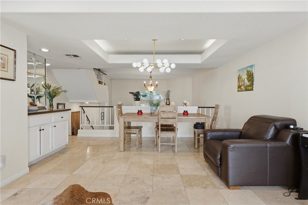 5340 Las Virgenes Road, Unit 11 Calabasas, CA 91302 - Photo 13 of 46 a living room with furniture a chandelier and a dining table