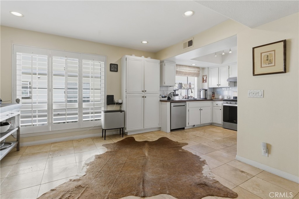 5340 Las Virgenes Road, Unit 11 Calabasas, CA 91302 - Photo 16 of 46 a kitchen with stainless steel appliances a stove a sink and a refrigerator
