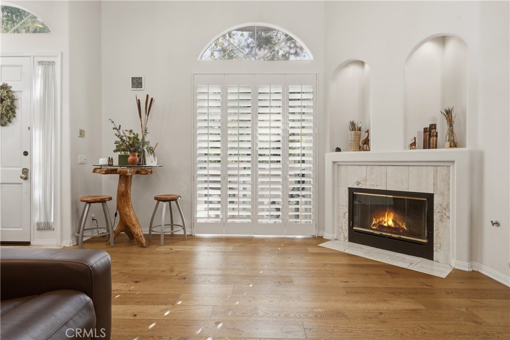 5340 Las Virgenes Road, Unit 11 Calabasas, CA 91302 - Photo 2 of 46 a living room with furniture a fireplace and a chandelier