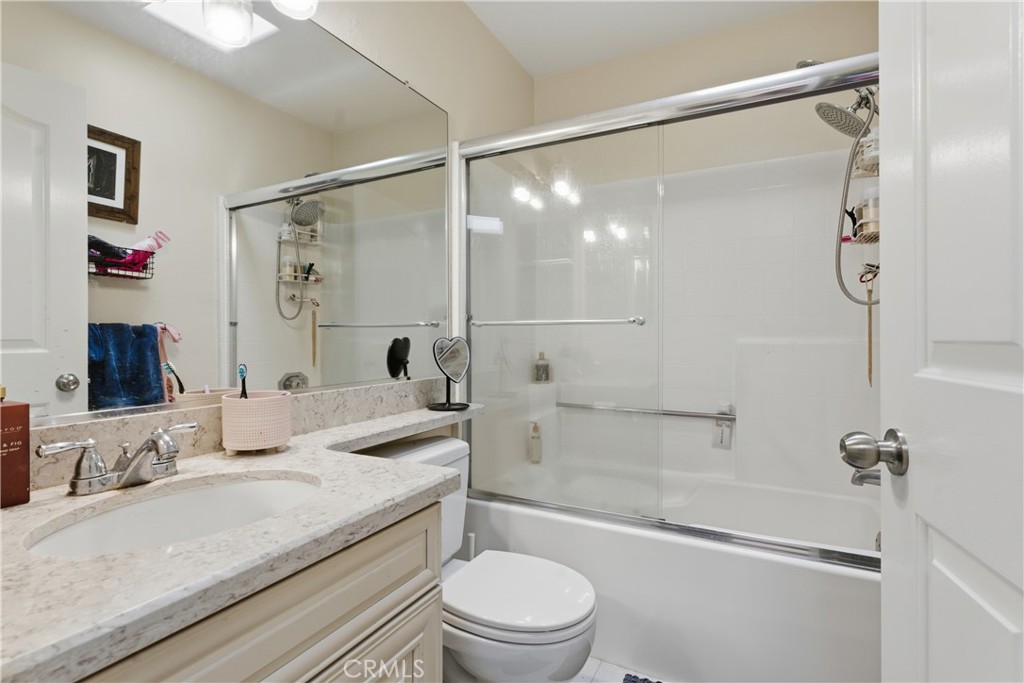 5340 Las Virgenes Road, Unit 11 Calabasas, CA 91302 - Photo 22 of 46 a bathroom with a granite countertop sink mirror toilet and bathtub