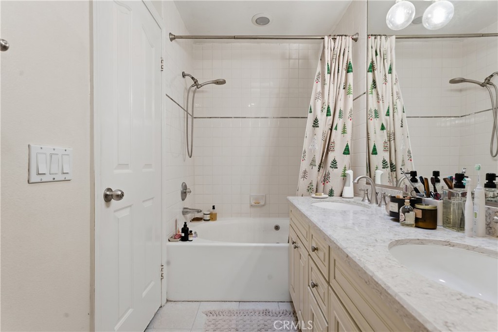 5340 Las Virgenes Road, Unit 11 Calabasas, CA 91302 - Photo 26 of 46 a bathroom with a granite countertop sink a mirror and shower