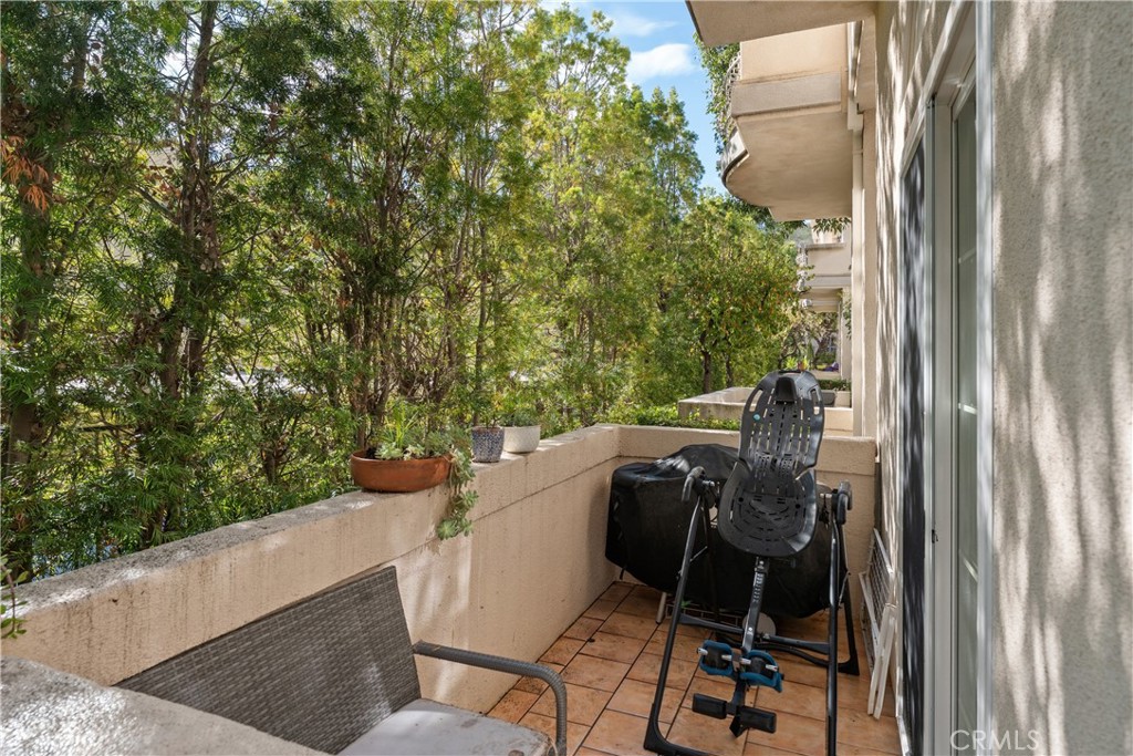 5340 Las Virgenes Road, Unit 11 Calabasas, CA 91302 - Photo 29 of 46 a view of balcony with chair and wooden fence