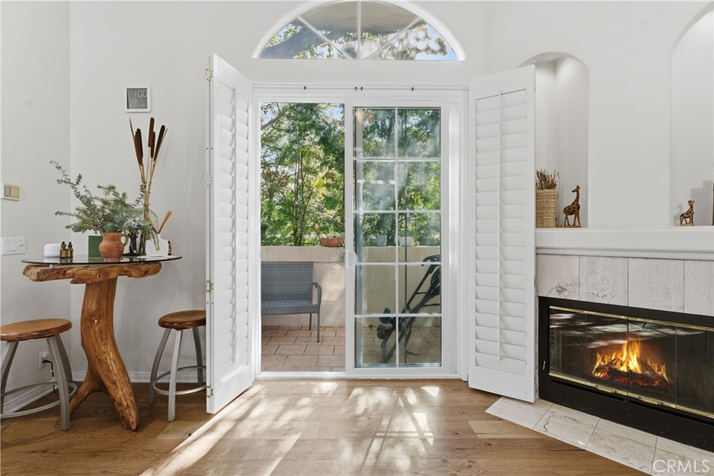 5340 Las Virgenes Road, Unit 11 Calabasas, CA 91302 - Photo 3 of 46 a living room with furniture a fireplace and a floor to ceiling window
