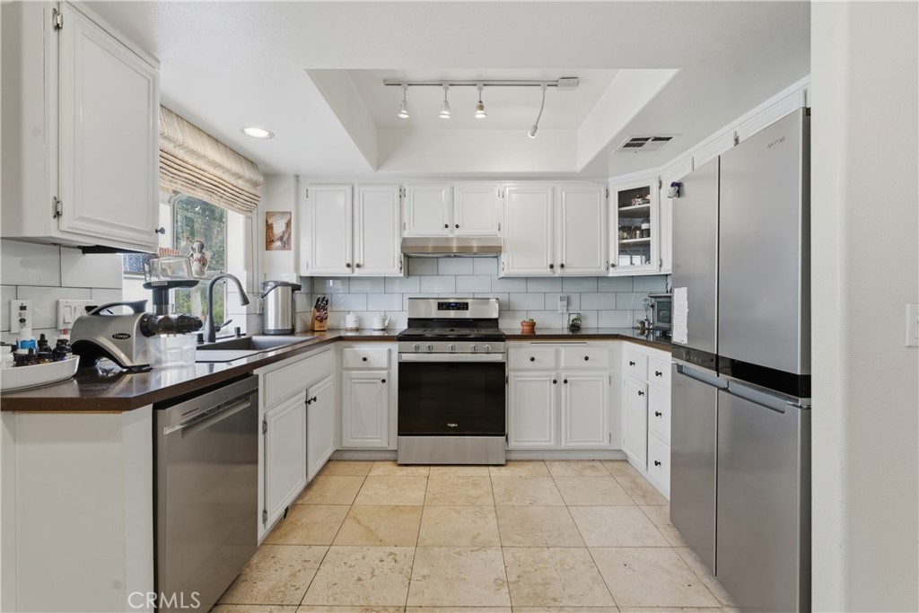 5340 Las Virgenes Road, Unit 11 Calabasas, CA 91302 - Photo 9 of 46 a kitchen with a white cabinets and refrigerator