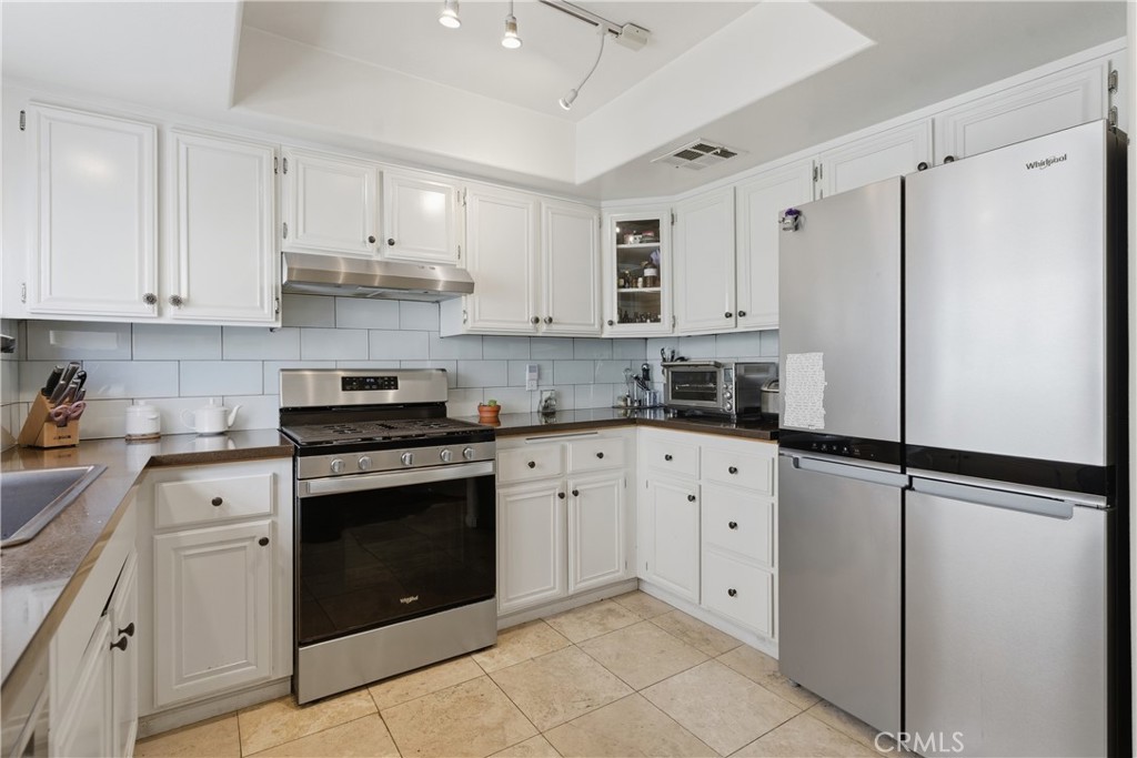 5340 Las Virgenes Road, Unit 11 Calabasas, CA 91302 - Photo 10 of 46 a kitchen with cabinets appliances and a sink